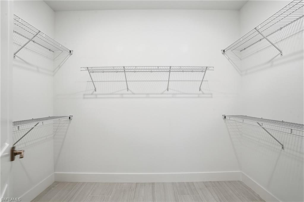 2148 Sequoia Court Naples, FL 34113 - Photo 13 of 48 a view of a room with racks on the wall
