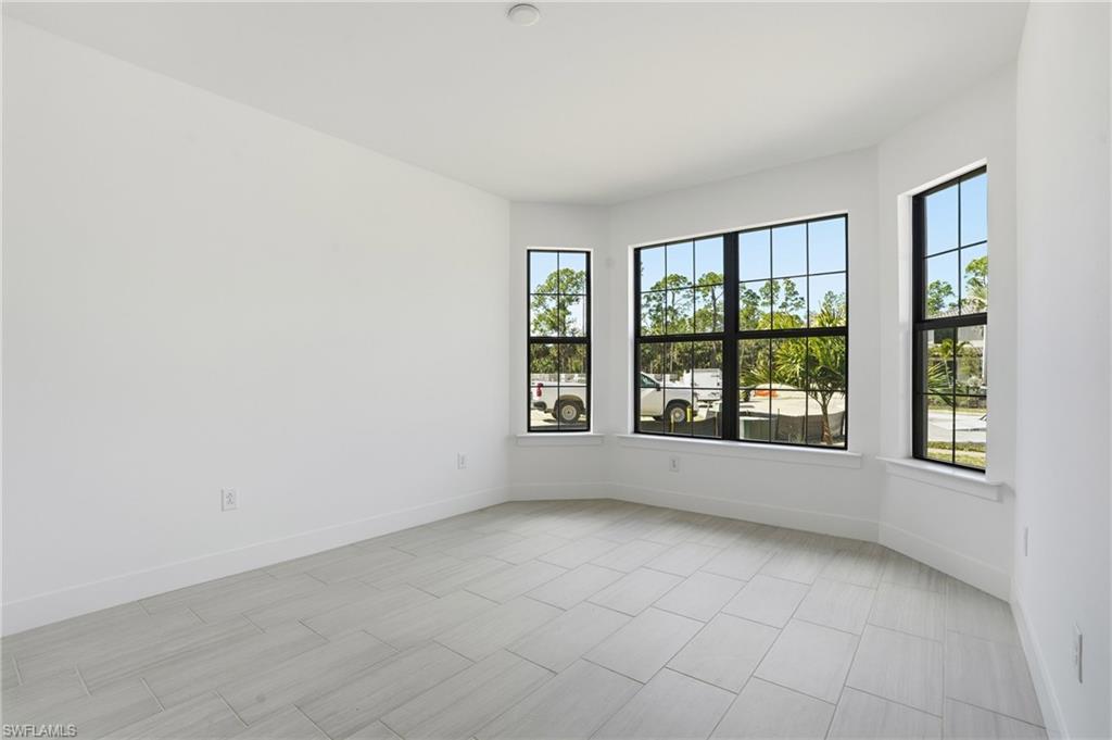 2148 Sequoia Court Naples, FL 34113 - Photo 17 of 48 an empty room with windows