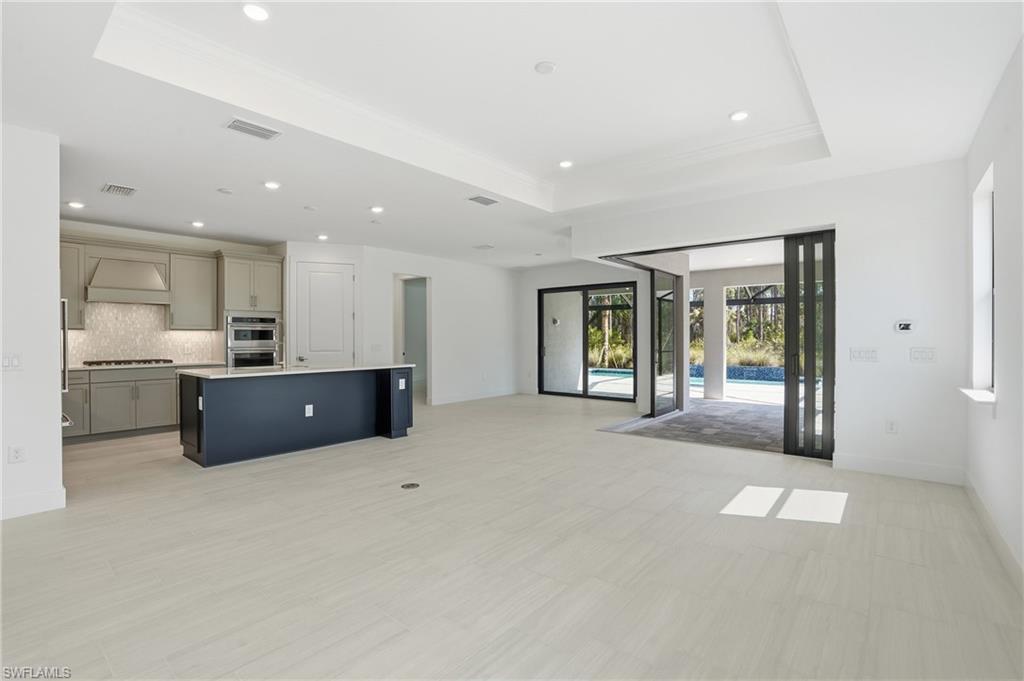 2148 Sequoia Court Naples, FL 34113 - Photo 2 of 48 a open hall with kitchen island