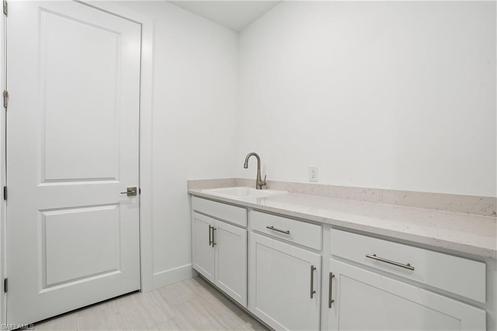 2148 Sequoia Court Naples, FL 34113 - Photo 25 of 48 a bathroom with a sink and vanity