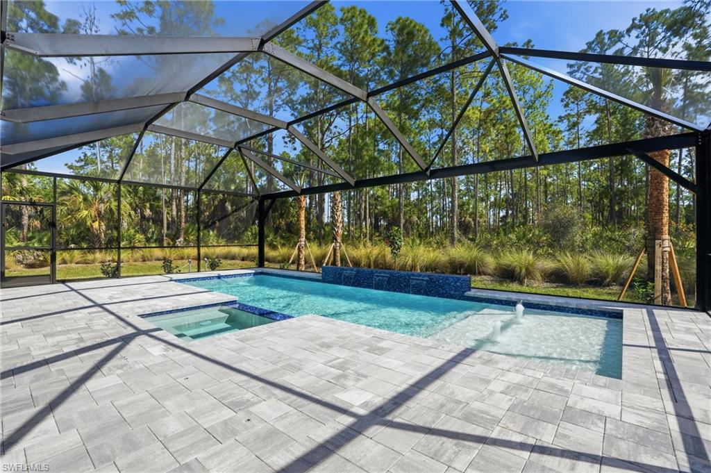 2148 Sequoia Court Naples, FL 34113 - Photo 30 of 48 a view of swimming pool with a patio and plants