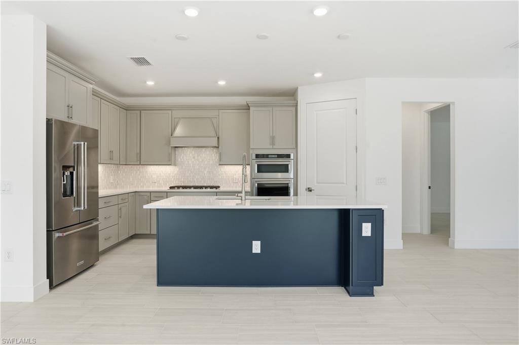2148 Sequoia Court Naples, FL 34113 - Photo 6 of 48 a kitchen with stainless steel appliances granite countertop a refrigerator and a sink