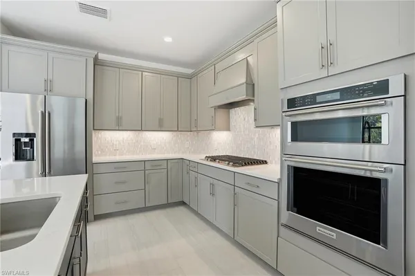 a kitchen with granite countertop cabinets stainless steel appliances and sink