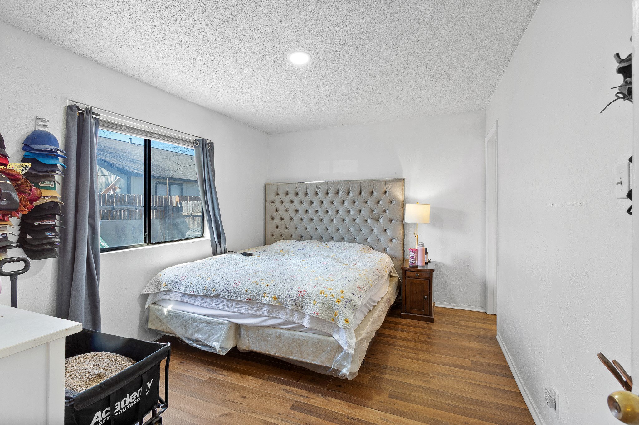 606 Misty Morning Way, Unit A AND B Round Rock, TX 78664 - Photo 13 of 22 Bedroom with wood finished floors and a textured ceiling
