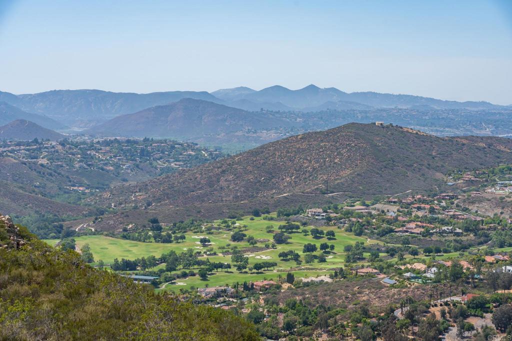 18000 Sunset Point Road Poway, CA 92064 - Photo 32 of 36 a view of a lush green hillside and a houses
