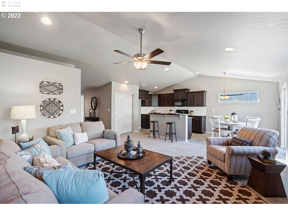 5320 Squirrel Street Springfield, OR 97478 - Photo 2 of 5 a living room with lots of furniture and view of kitchen