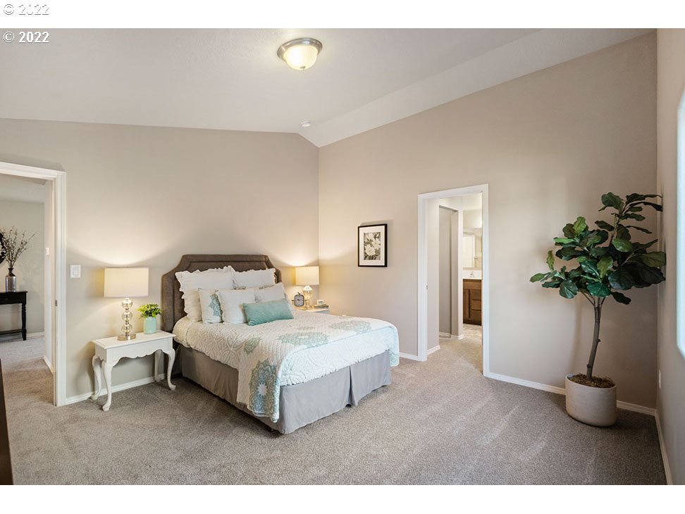 5320 Squirrel Street Springfield, OR 97478 - Photo 4 of 5 a bedroom with a bed and a potted plant