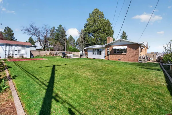 a view of backyard of house with seating space