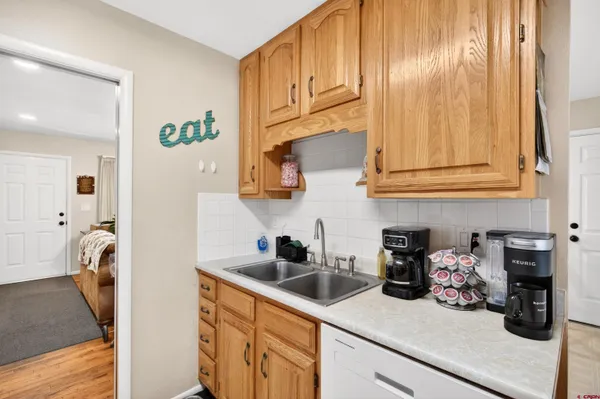 a kitchen with stainless steel appliances granite countertop a sink a stove and cabinets