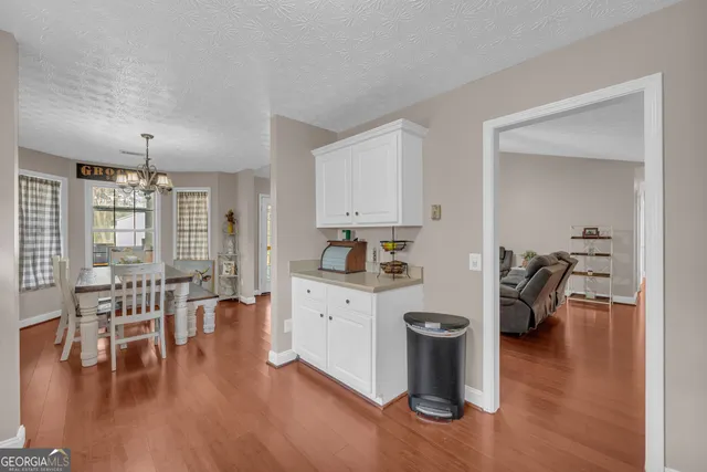 a kitchen with a table and chairs in it
