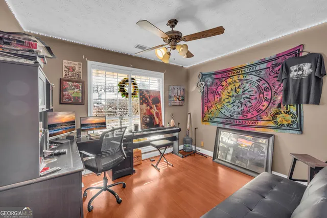 a view of a livingroom with furniture and a ceiling fan