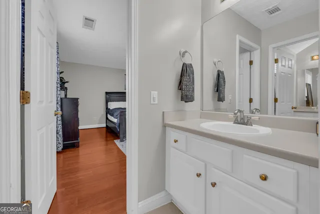 a bathroom with a double vanity sink and a mirror