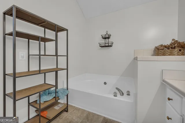 a bathroom with a bathtub and shower