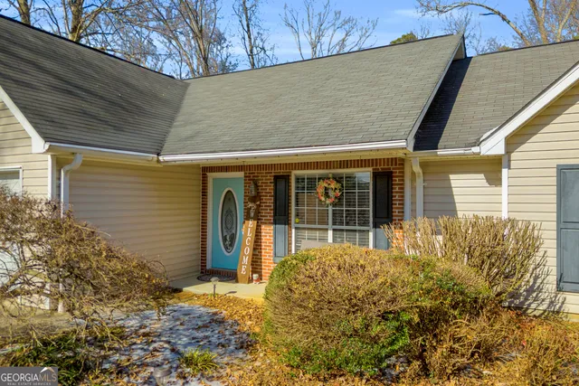 a front view of a house with garden