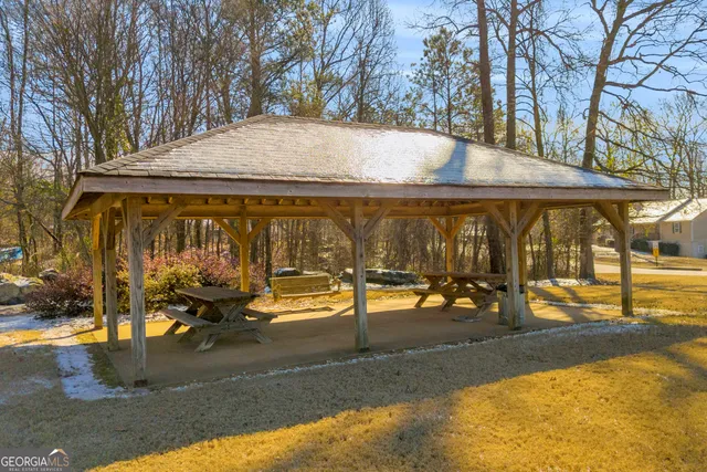 an outdoor space with pool and sitting space