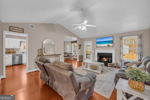 a living room with furniture a fireplace and a table