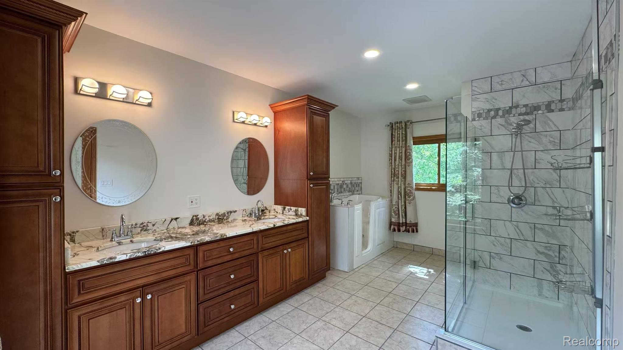 3440 Salem Drive Rochester, MI 48306 - Photo 27 of 33 Bathroom featuring a dual vanity with a granite countertop, wood cabinetry, and two round mirrors