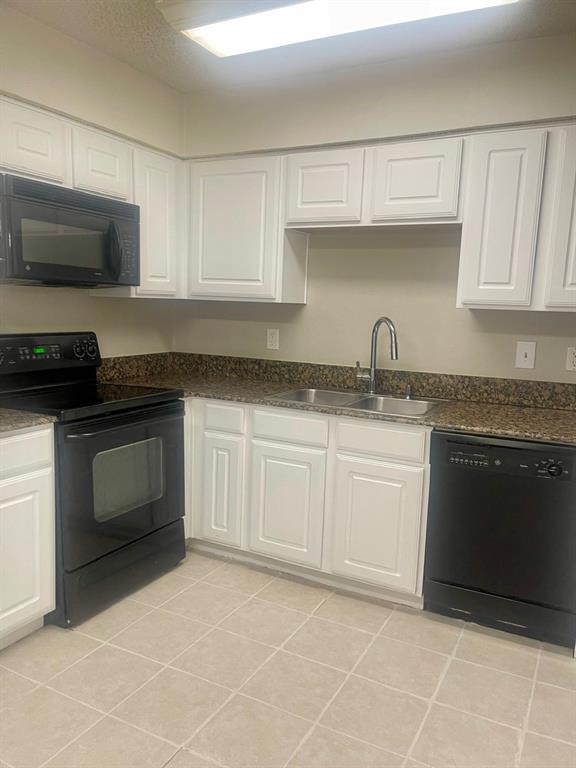 5300 Keller Springs Road, Unit 2080 Dallas, TX 75248 - Photo 16 of 28 a kitchen with granite countertop white cabinets and stainless steel appliances