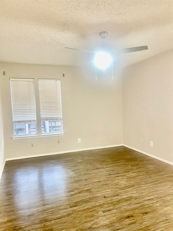 5300 Keller Springs Road, Unit 2080 Dallas, TX 75248 - Photo 18 of 28 a view of an empty room with wooden floor and a window