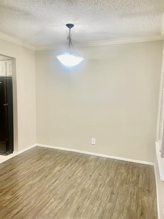 5300 Keller Springs Road, Unit 2080 Dallas, TX 75248 - Photo 26 of 28 a view of an empty room with wooden floor