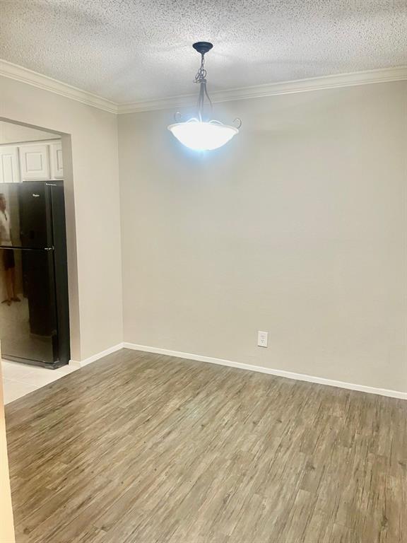 5300 Keller Springs Road, Unit 2080 Dallas, TX 75248 - Photo 27 of 28 a view of an empty room with wooden floor and a window