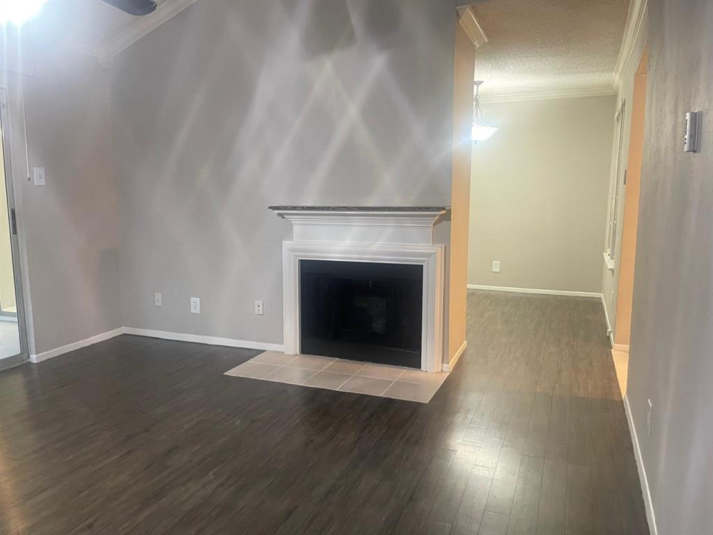 5300 Keller Springs Road, Unit 2080 Dallas, TX 75248 - Photo 5 of 28 a view of a livingroom with wooden floor and a fireplace