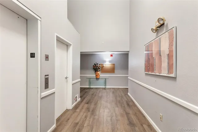 a view of a hallway view with wooden floor and staircase
