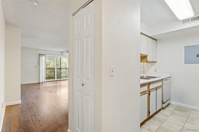 a kitchen with a stove a sink and a window