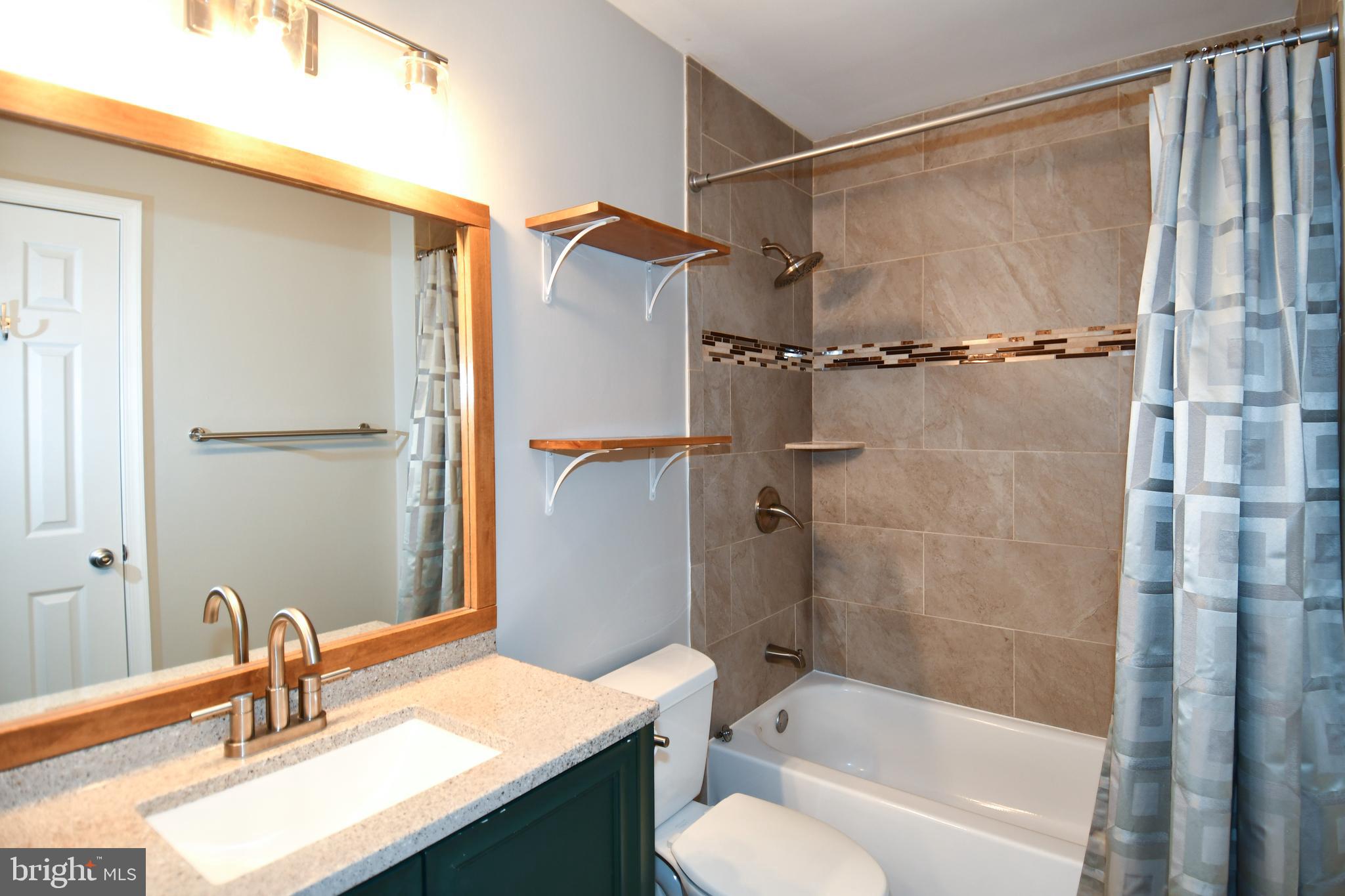 53 Essex Square Sterling, VA 20164 - Photo 11 of 25 a bathroom with a sink toilet tub and shower