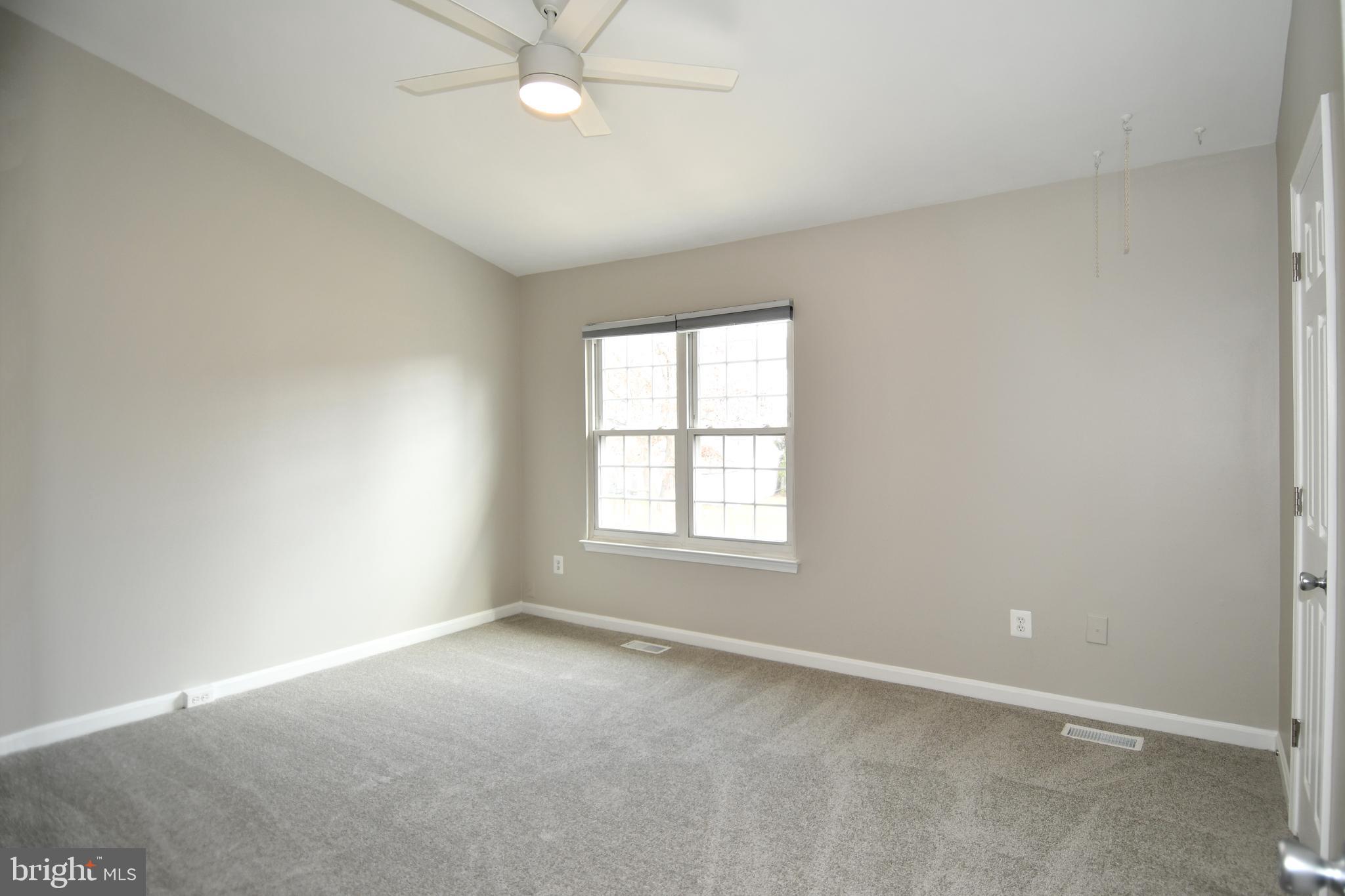 53 Essex Square Sterling, VA 20164 - Photo 15 of 25 an empty room with a window and a fan