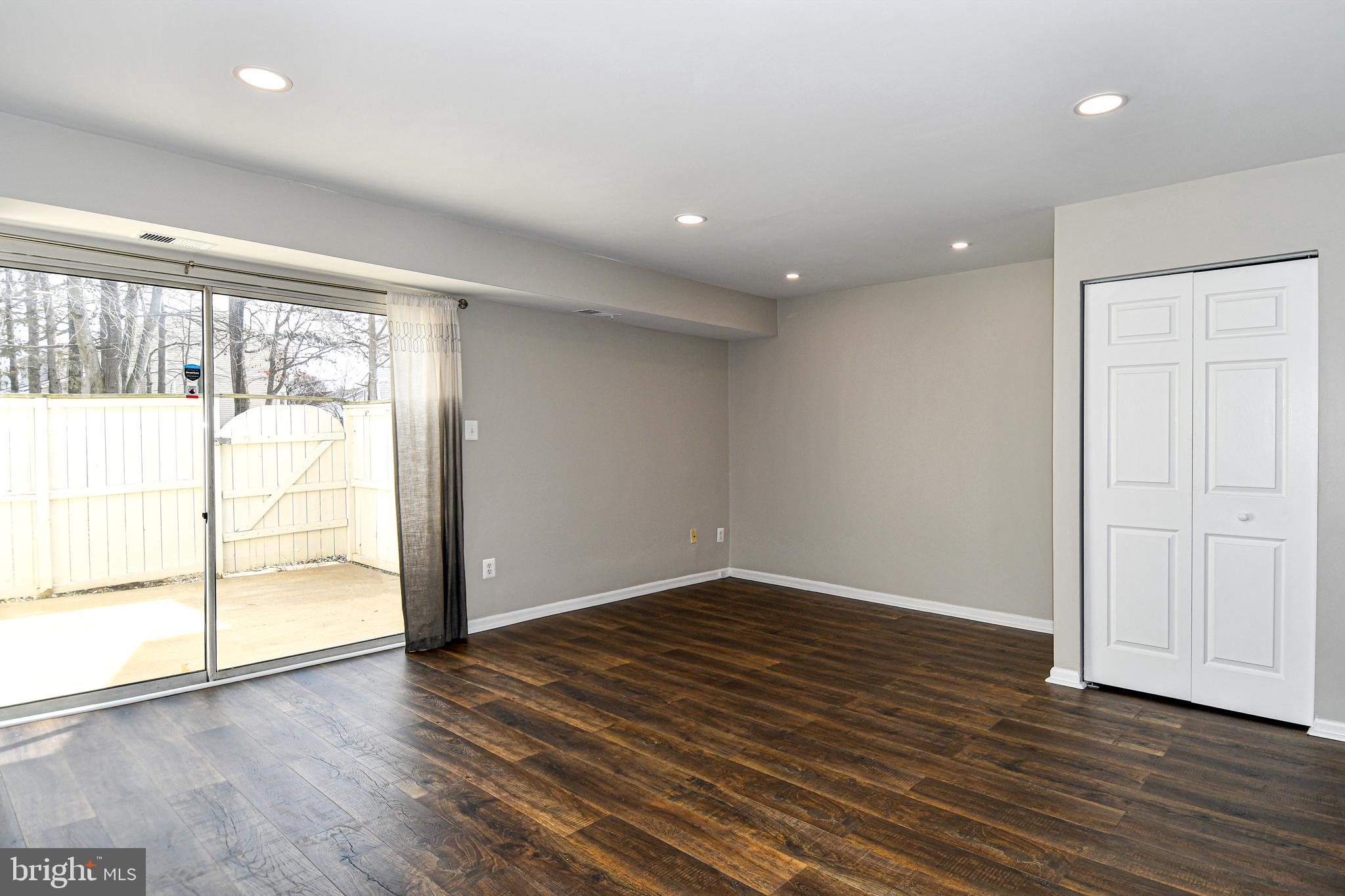 53 Essex Square Sterling, VA 20164 - Photo 9 of 25 an empty room with wooden floor and sliding door