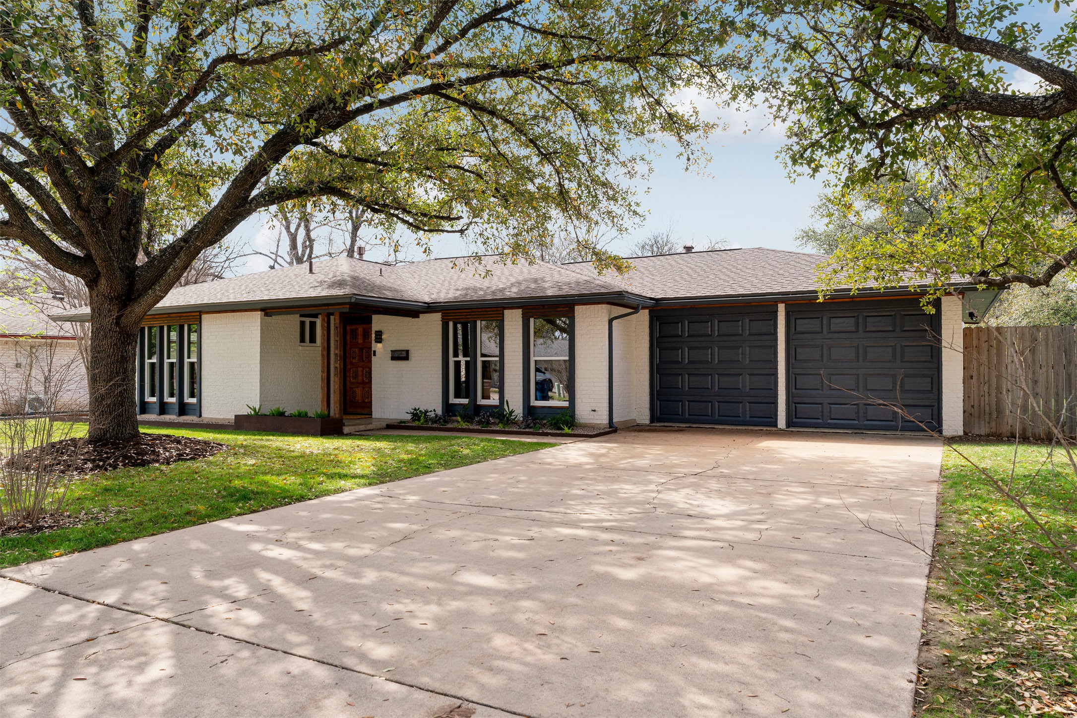 South Central Austin curb appeal with thoughtful upgrades already in place. Creamy exterior paint paired with cedar accents creates a warm, eye-catching front presence, while the updated roof, front gutters, and refreshed fencing reflect the extensive improvements made to the home over time