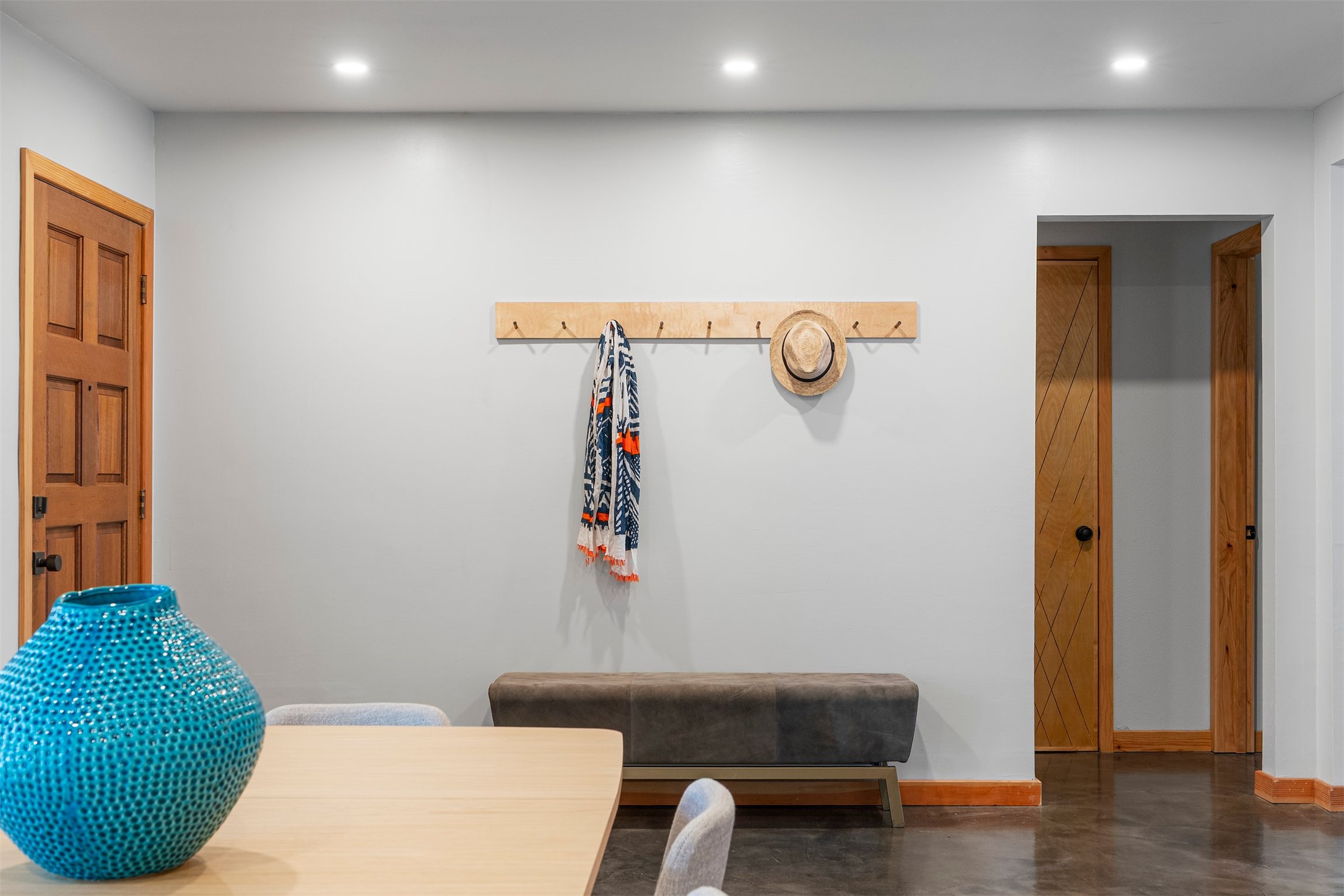 1111 Radam Circle Austin, TX 78745 - Photo 13 of 40 Step through the front door and the character of the home is immediately clear with stained concrete floors underfoot, handcrafted solid core interior doors, custom ironwork, and steel light fixtures that carry a thoughtful, artisan feel throughout the space