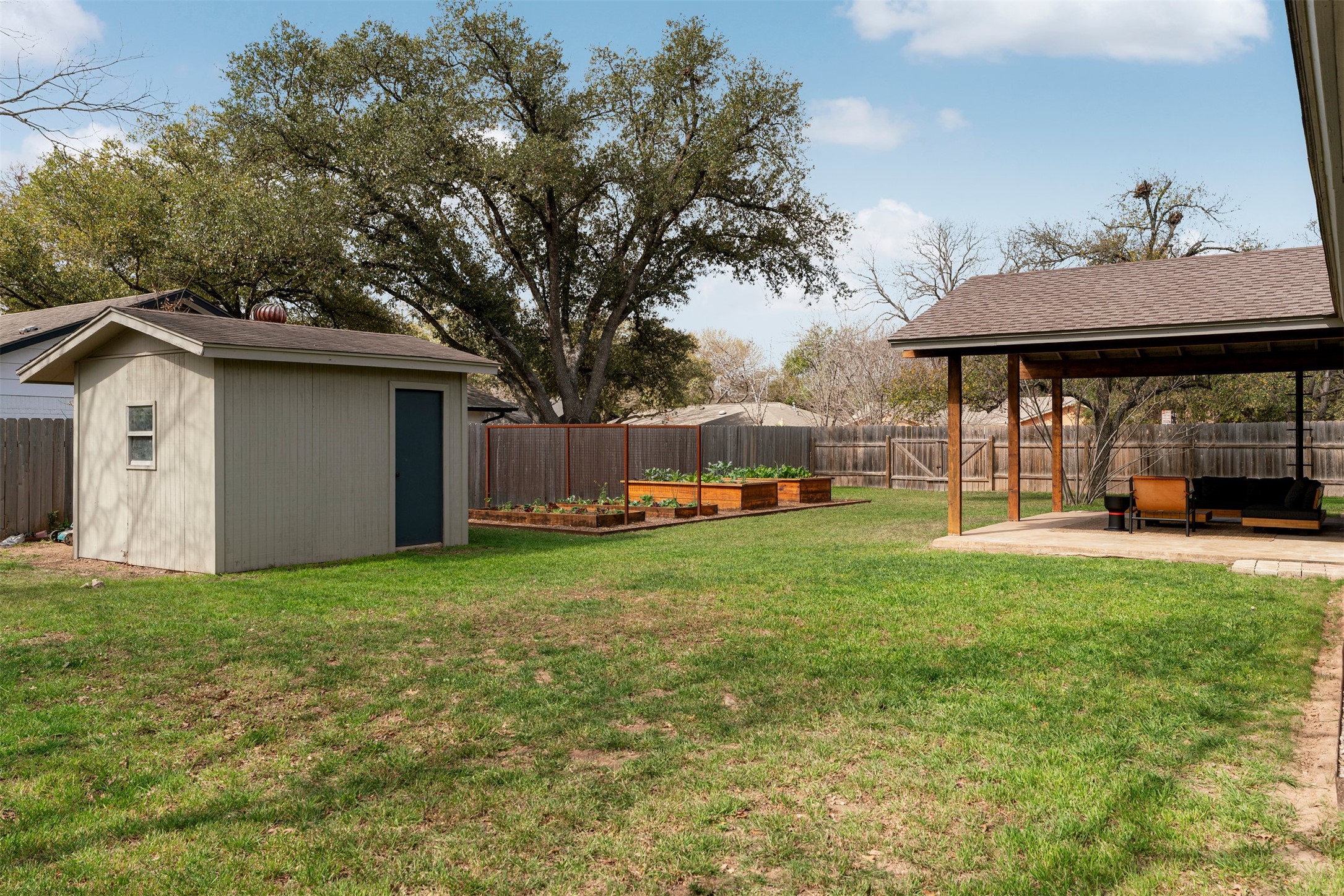 1111 Radam Circle Austin, TX 78745 - Photo 38 of 40 A storage shed sits at the back of the yard, providing a convenient place to store tools, lawn equipment, or supplies for gardening and outdoor hobbies