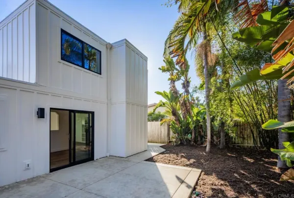 a view of empty room with wooden floor and fireplace