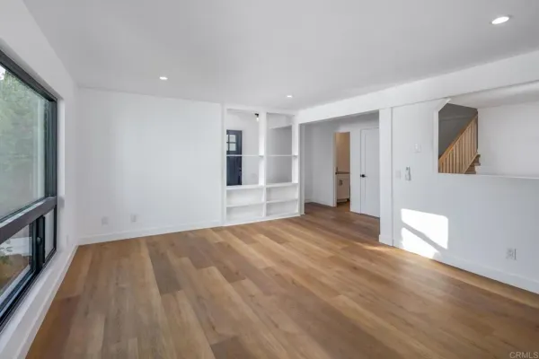 a kitchen with a sink cabinets stainless steel appliances and a large window