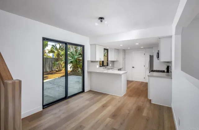 a kitchen with sink attached with living room