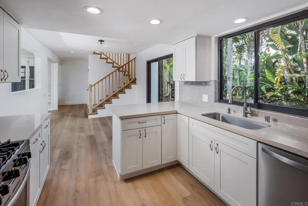 250 Hillcrest Drive Encinitas, CA 92024 - Photo 23 of 54 a kitchen with sink attached with living room