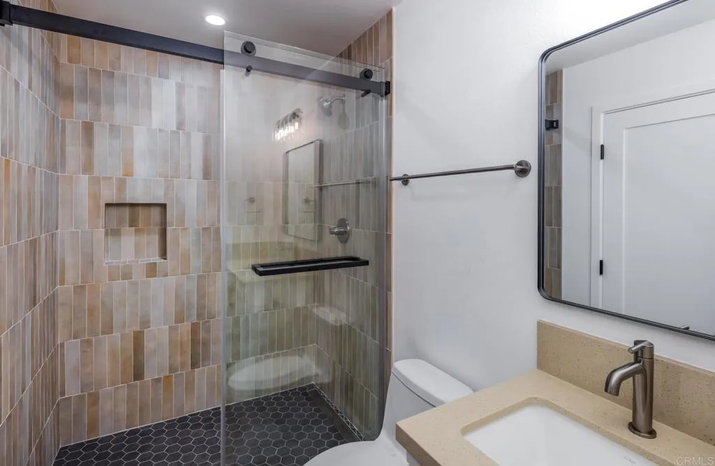 250 Hillcrest Drive Encinitas, CA 92024 - Photo 29 of 54 a bathroom with a shower and a sink