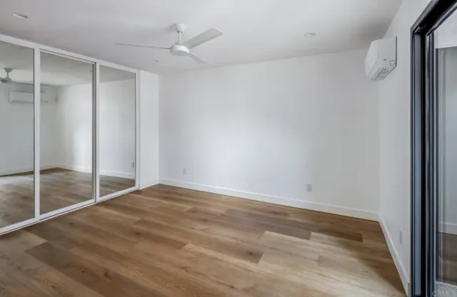 a bathroom with a shower sink vanity mirror and toilet