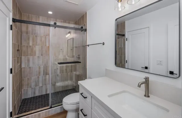 a kitchen with granite countertop a refrigerator stove and oven
