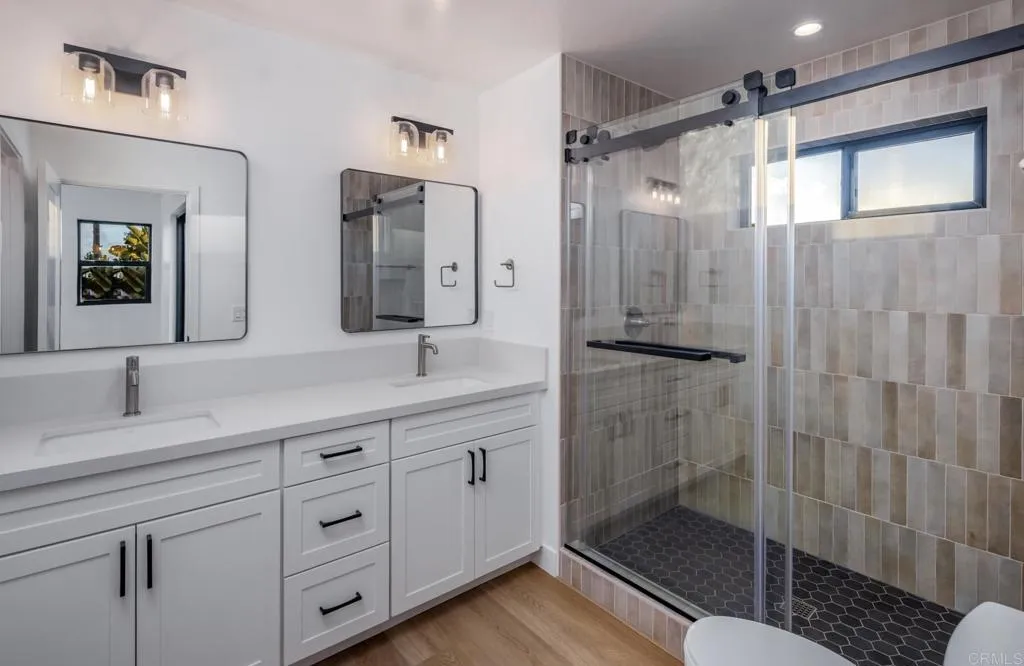 250 Hillcrest Drive Encinitas, CA 92024 - Photo 46 of 54 a bathroom with a shower sink and mirror