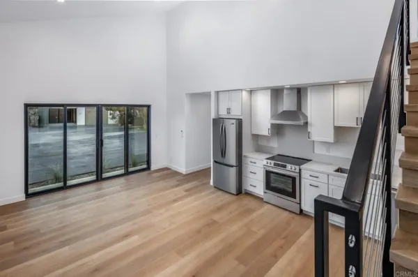 a view of empty room with wooden floor