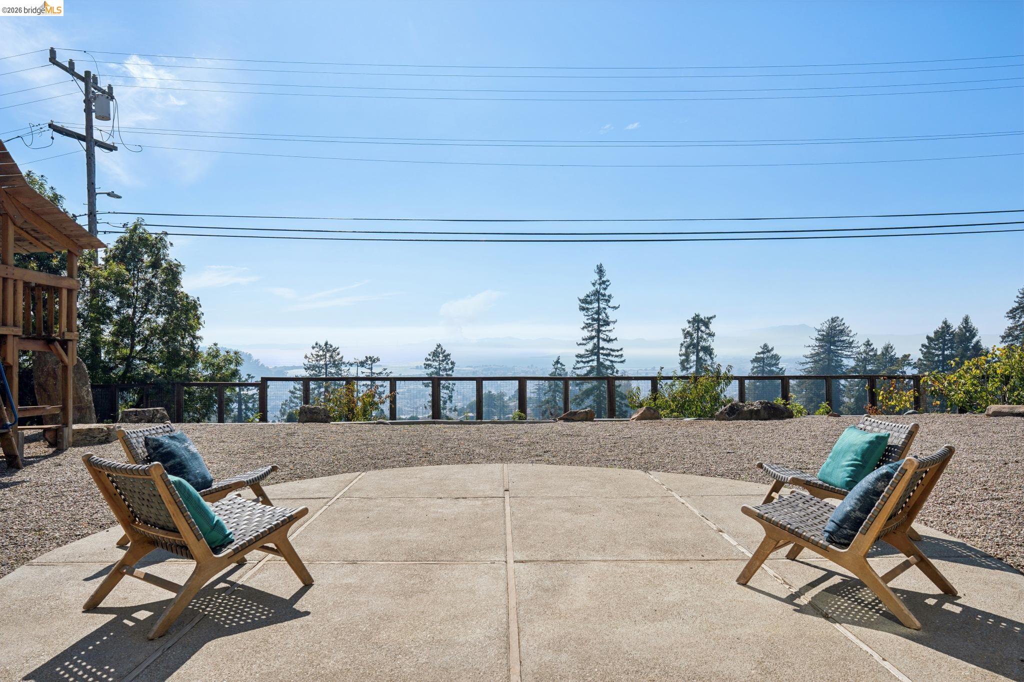 38 Highgate Road Kensington, CA 94707 - Photo 58 of 78 Expansive outdoor patio with concrete paving and gravel surfacing, featuring a wooden railing with wire infill