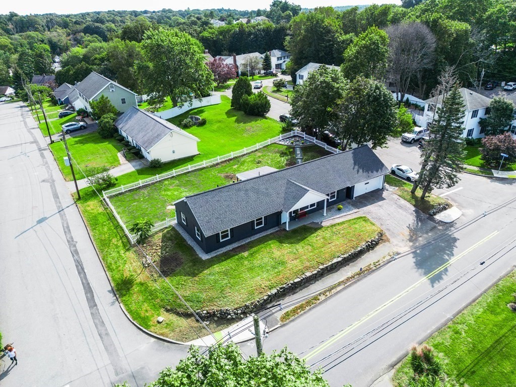 an aerial view of a house with a garden and swimming pool
