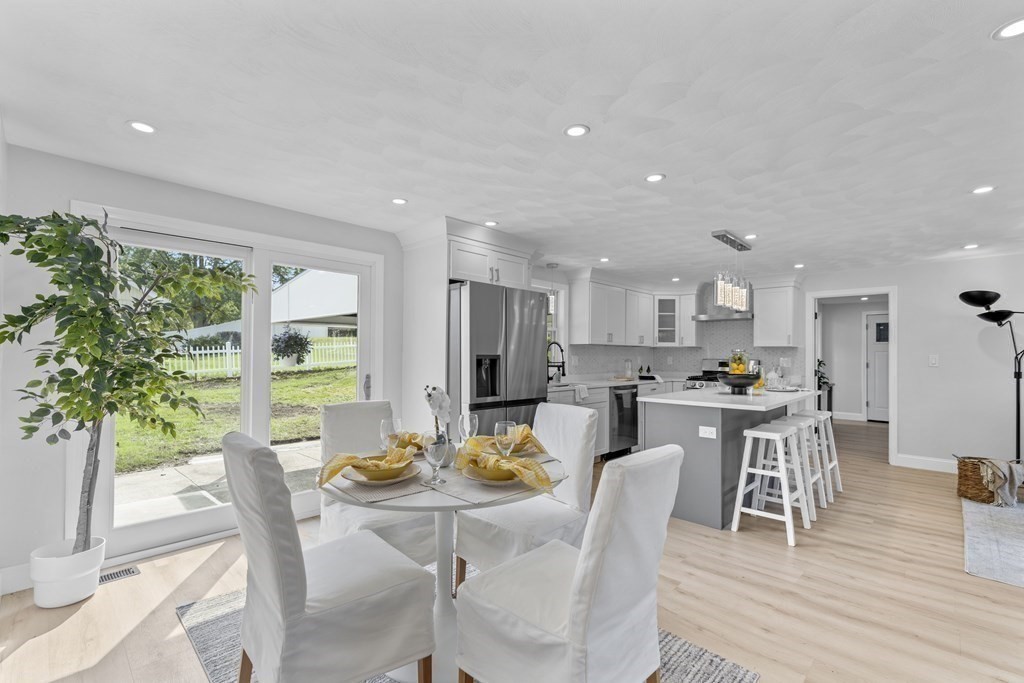 181 Green Street Stoneham, MA 02180 - Photo 11 of 42 a view of a dining room with furniture window and wooden floor