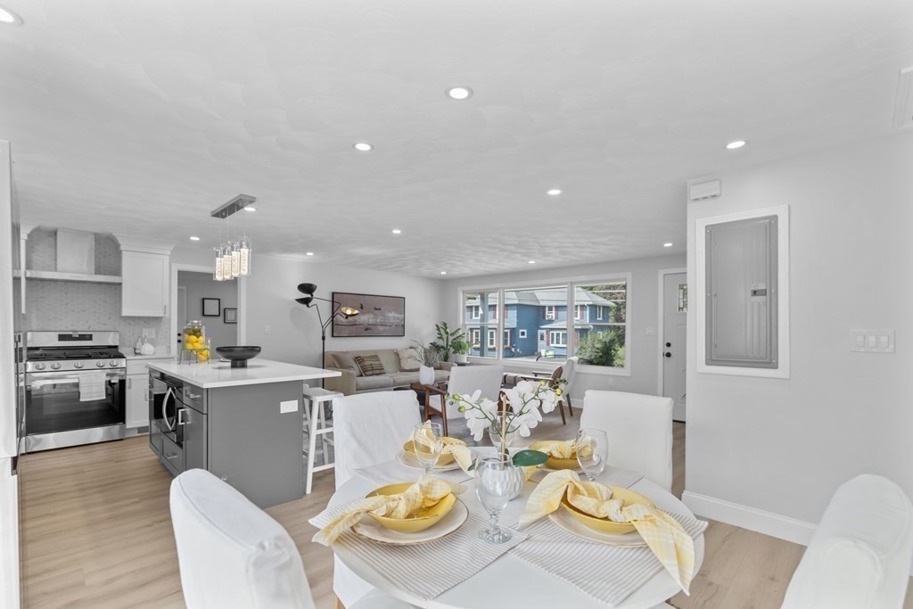 181 Green Street Stoneham, MA 02180 - Photo 12 of 42 a view of a dining room with furniture a kitchen and chandelier