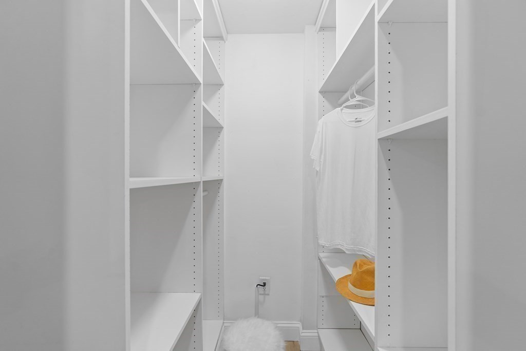 181 Green Street Stoneham, MA 02180 - Photo 20 of 42 a view of walk in closet with empty racks