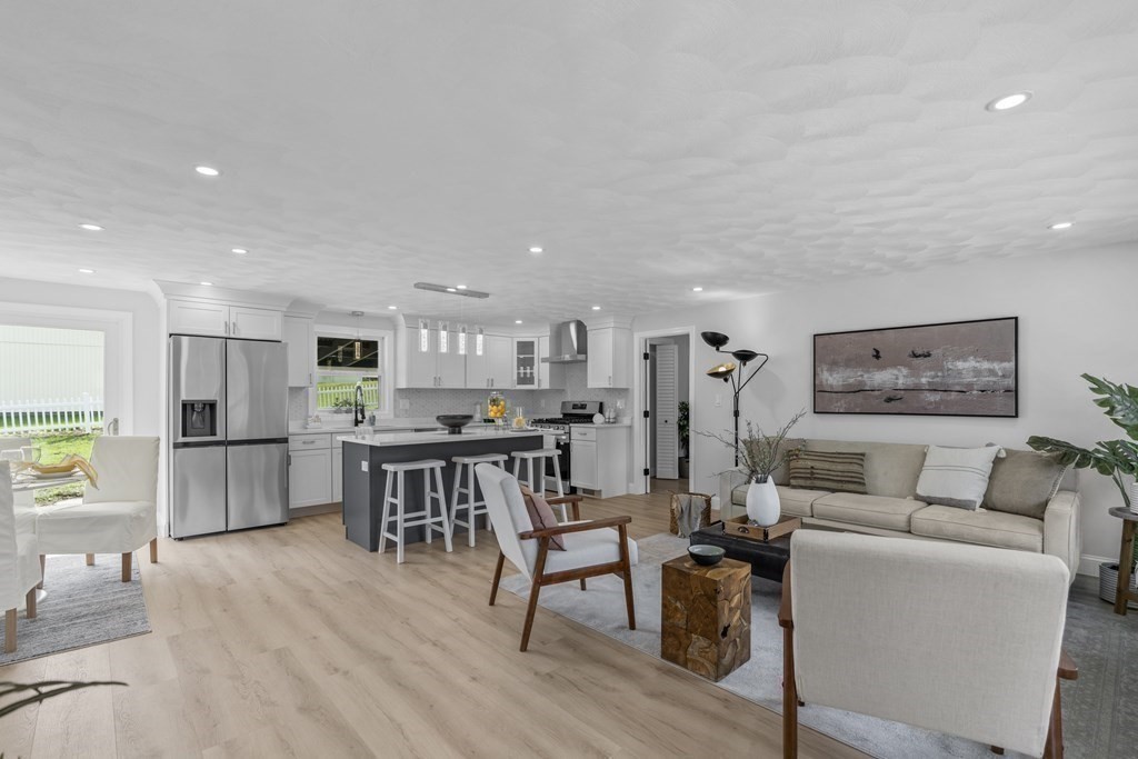 181 Green Street Stoneham, MA 02180 - Photo 2 of 42 a living room with furniture and kitchen view with wooden floor
