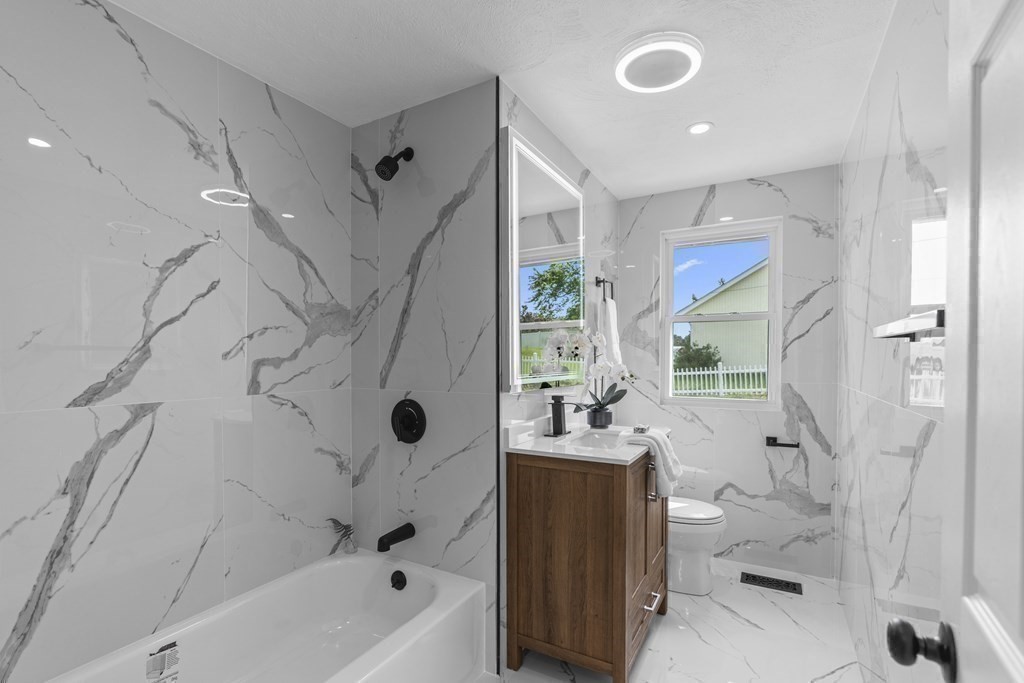 181 Green Street Stoneham, MA 02180 - Photo 22 of 42 a bathroom with a bathtub a sink and a shower
